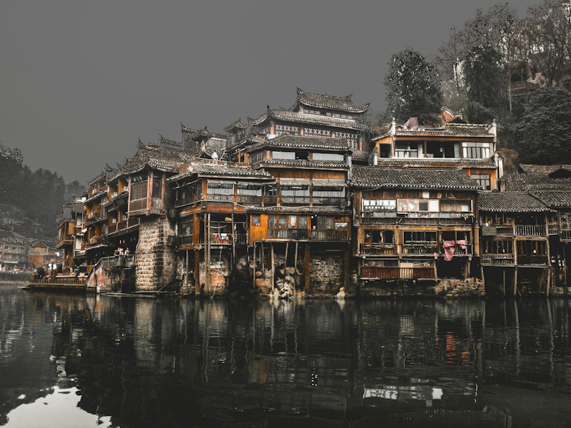 Fenghuang Ancient Town stilt houses along the Tuo River at dusk